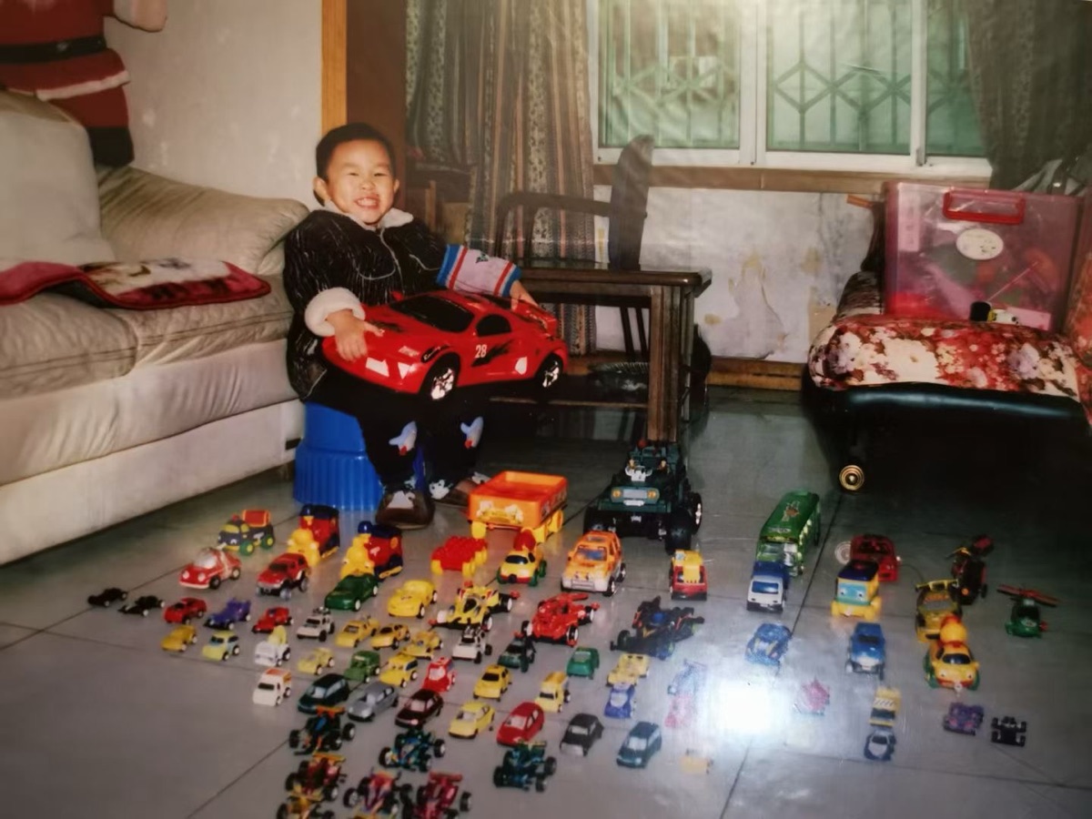 Childhood photo with toy car collection