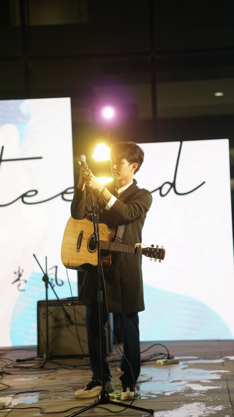 Performing guitar on stage at a music festival